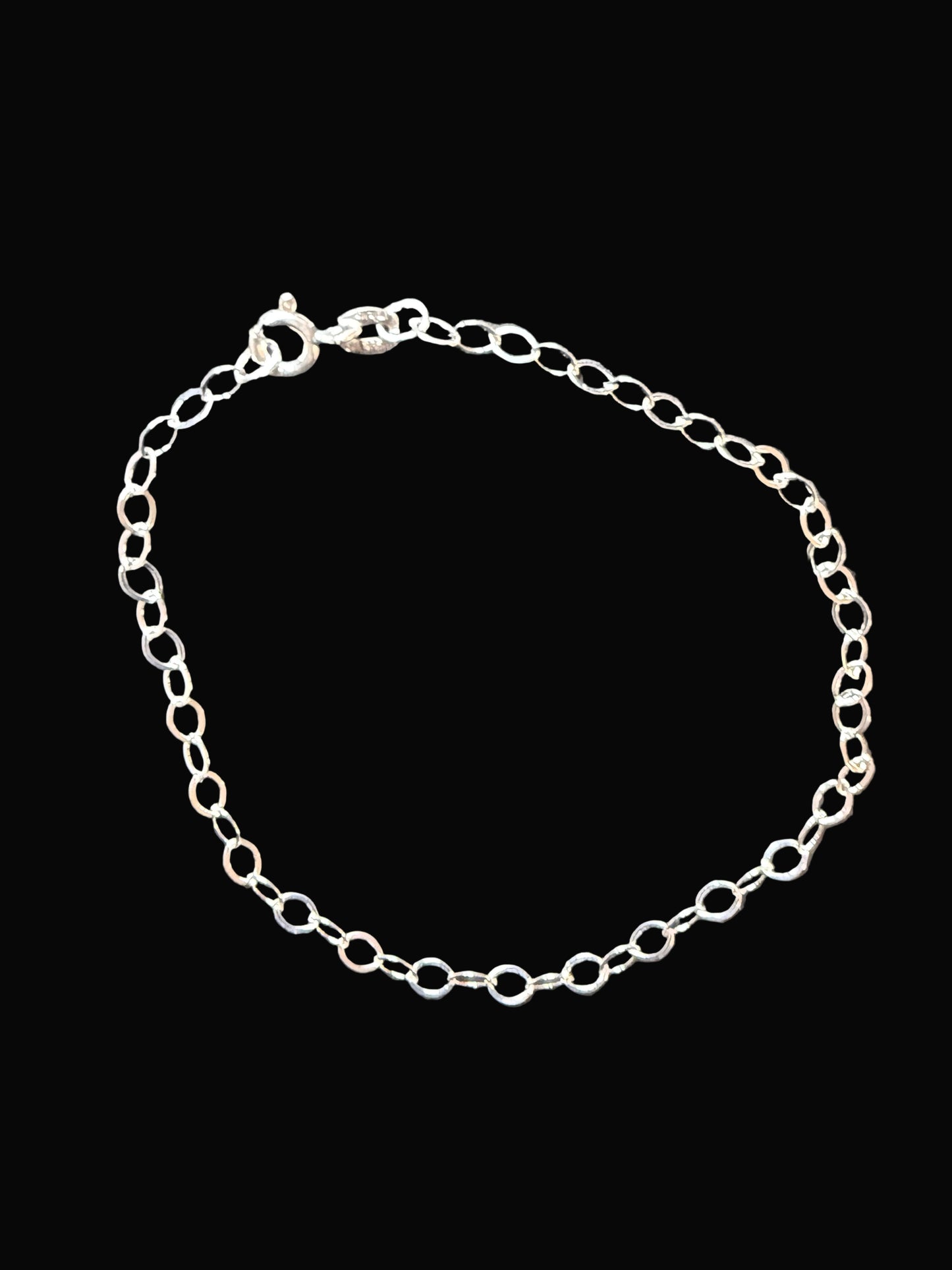 Silver chain bracelet on a dark gray surface