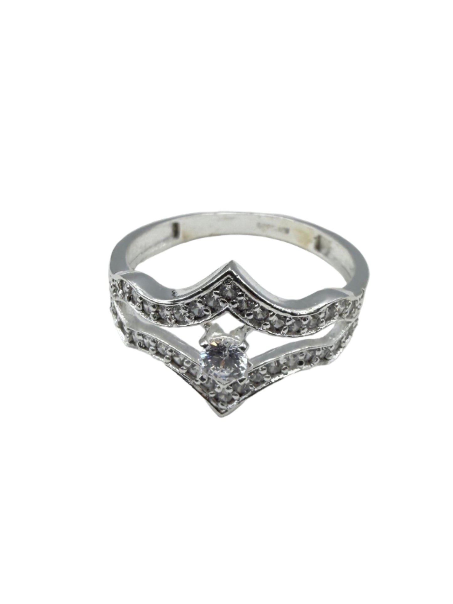 Silver ring with diamonds on a white textured surface