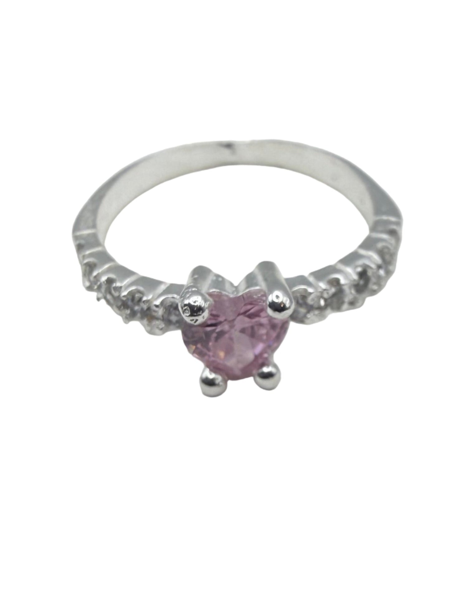 Silver ring with a pink gemstone on a white surface
