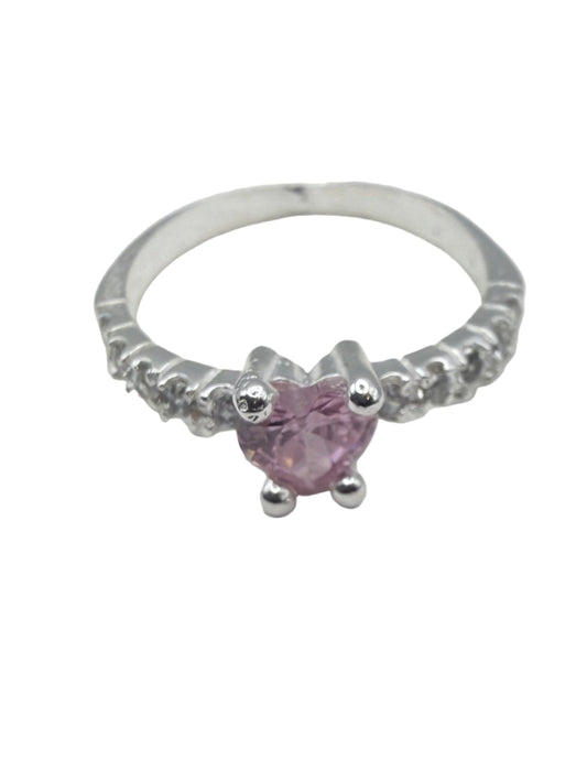Silver ring with a pink gemstone on a white surface
