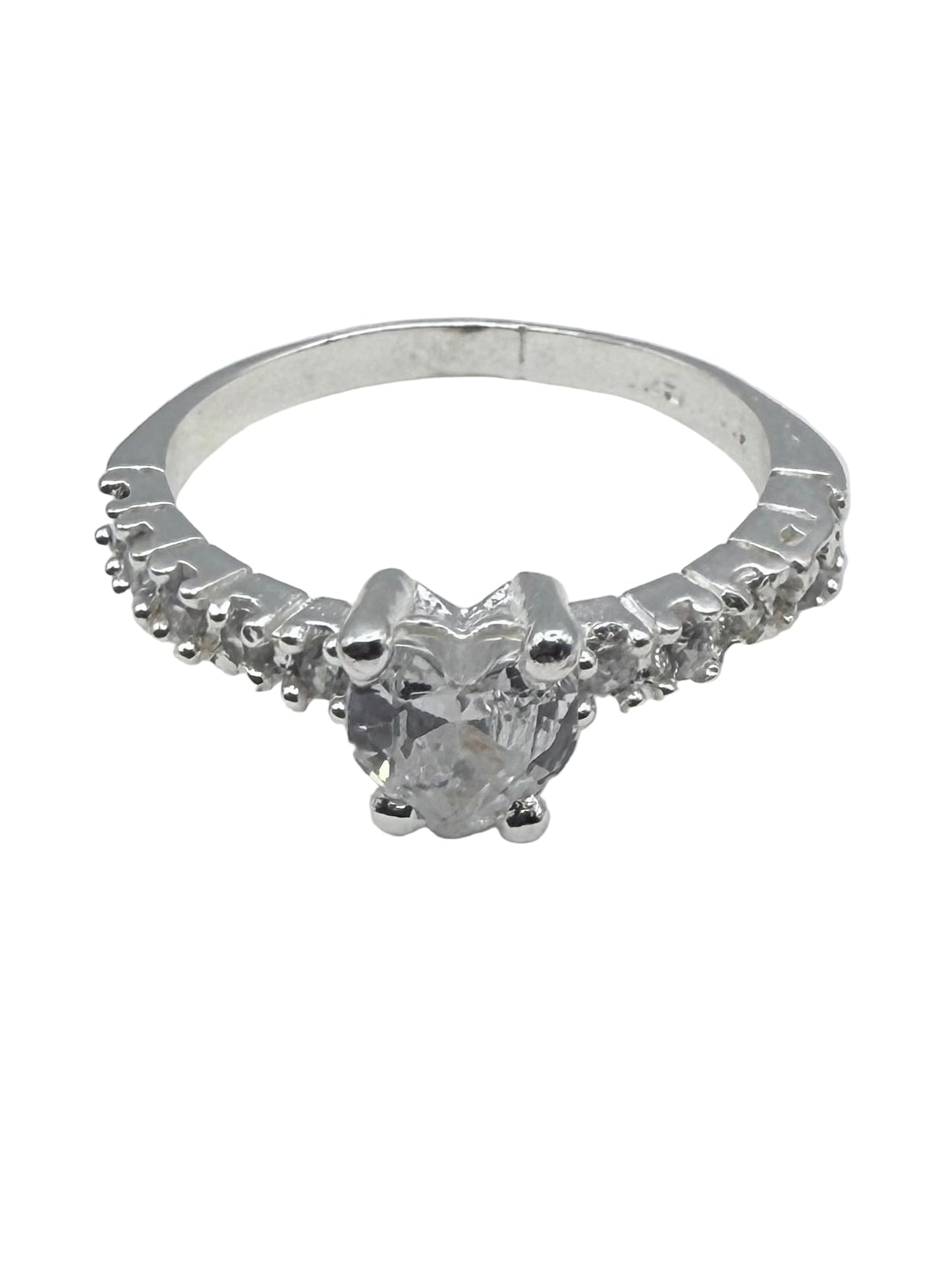 Silver ring with a diamond on a white surface