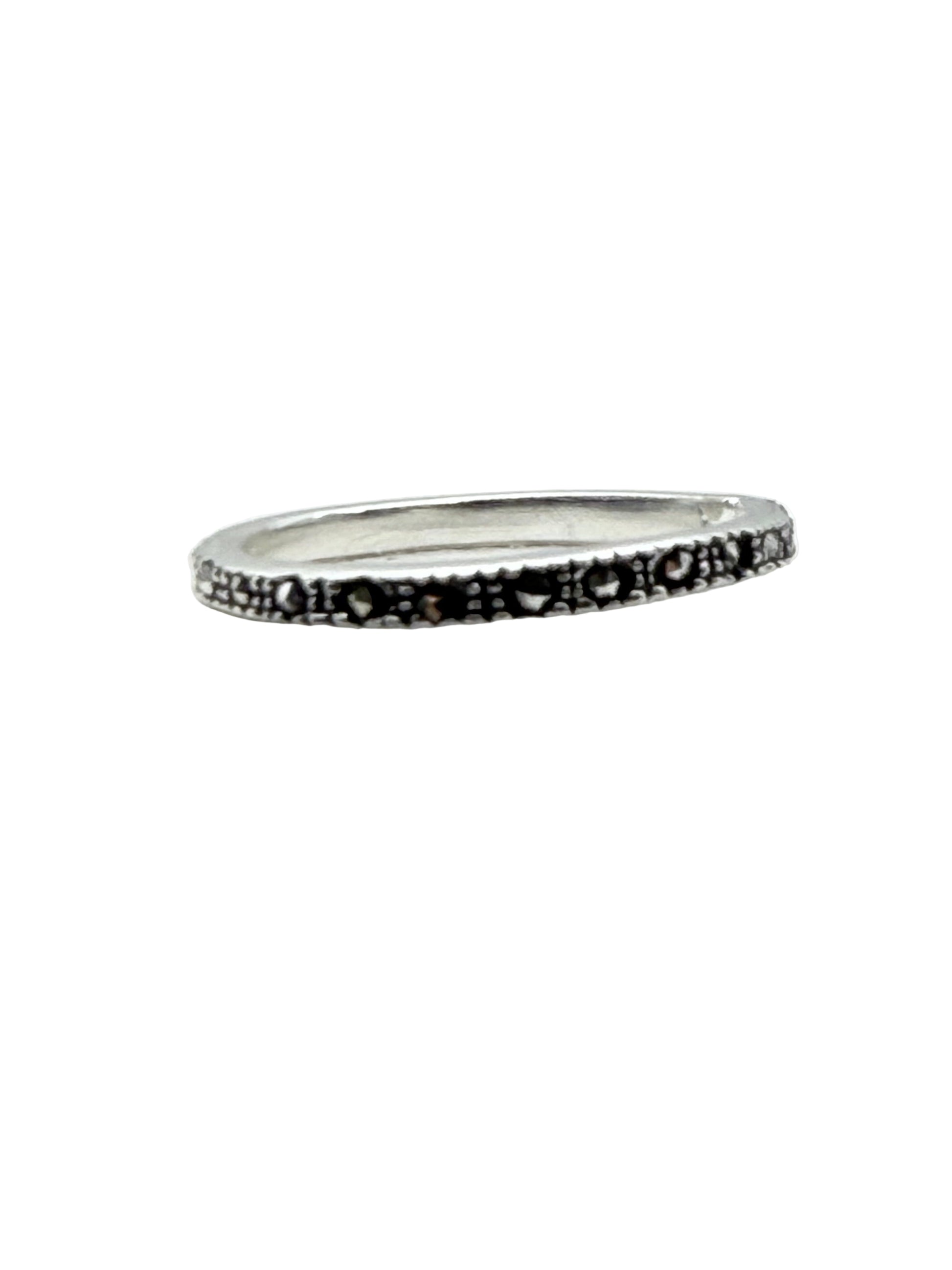 Silver ring with black pattern on a white background