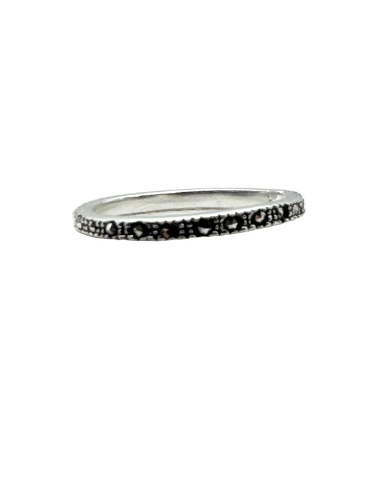 Silver ring with black pattern on a white background