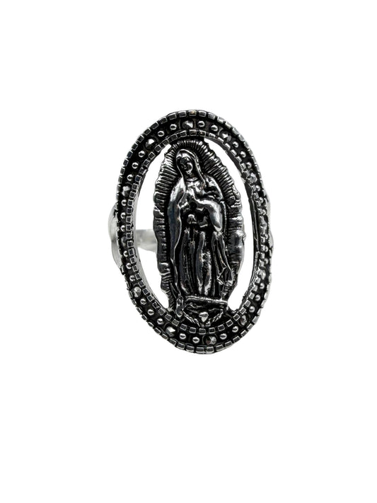 Silver ring with religious design on a white cushion