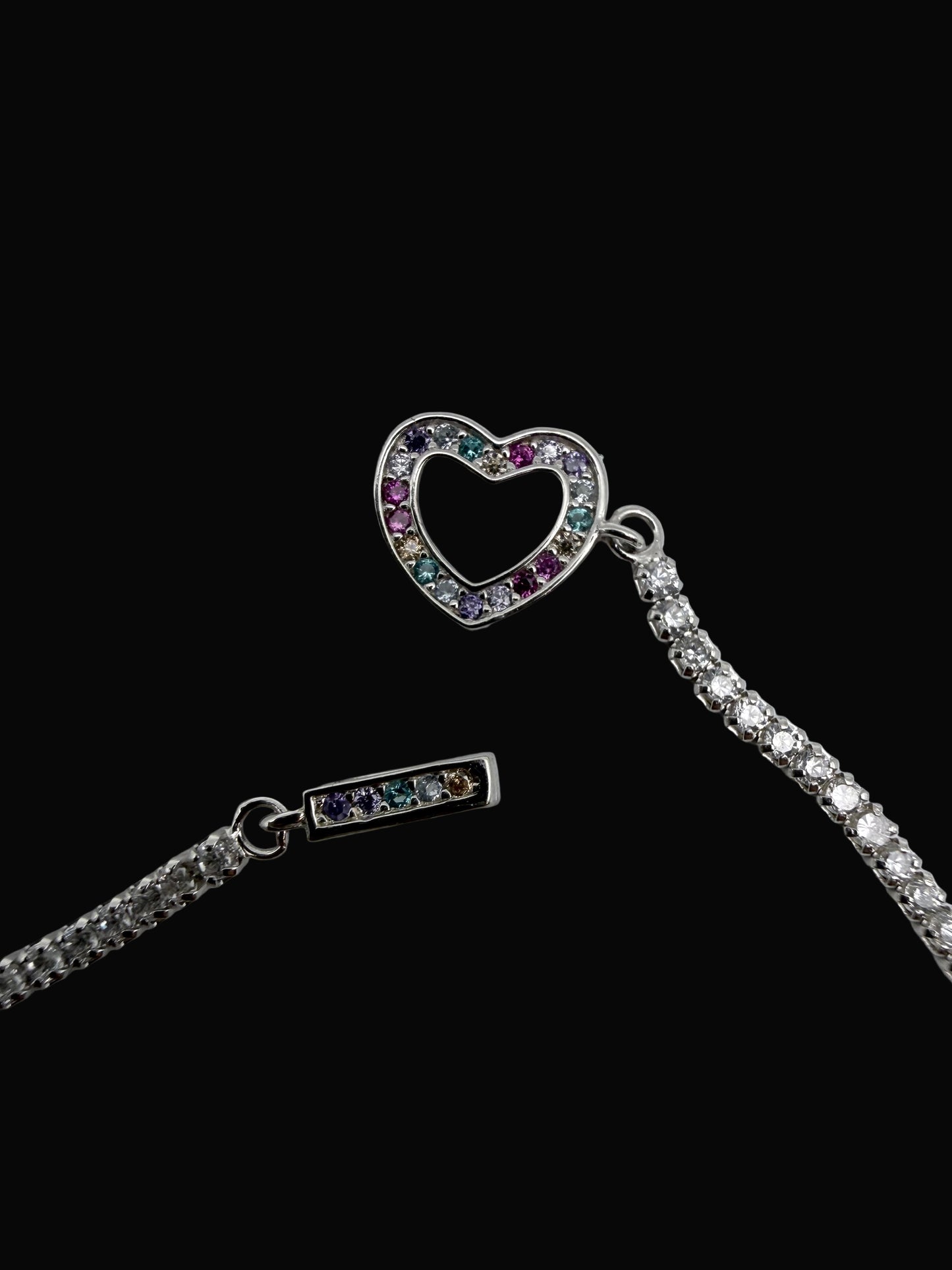 Necklace with heart-shaped and rectangular pendant on a light gray background