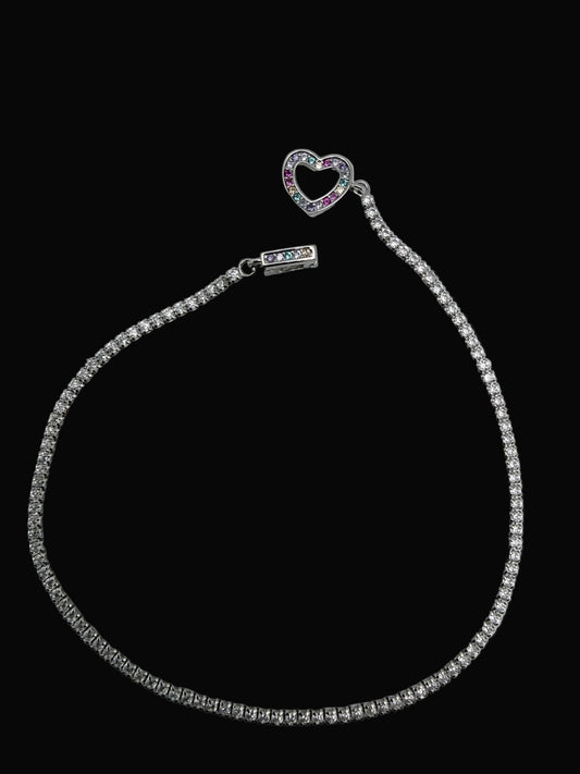 Silver bracelet with heart clasp on a black background