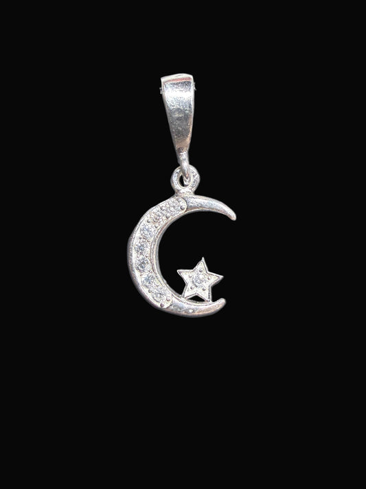 Silver ring with a moon and star design on a dark surface