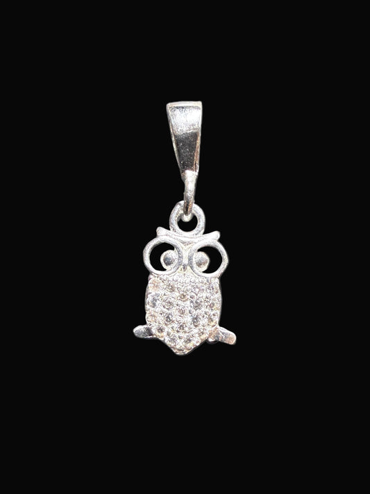 Silver owl pendant on a gray card