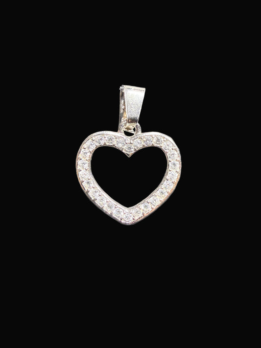Heart-shaped silver pendant on a clear card against a gray background