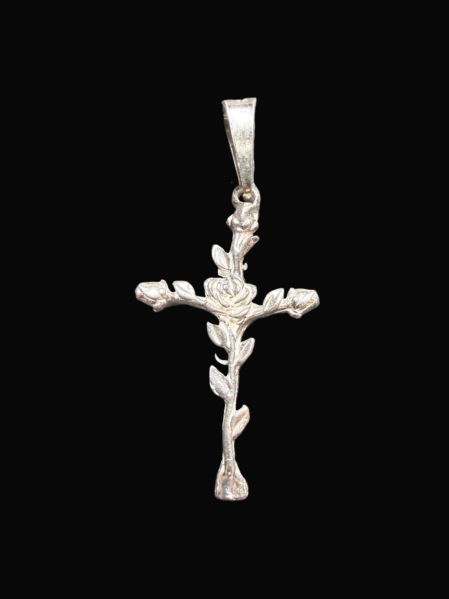 Silver cross pendant on a gray card