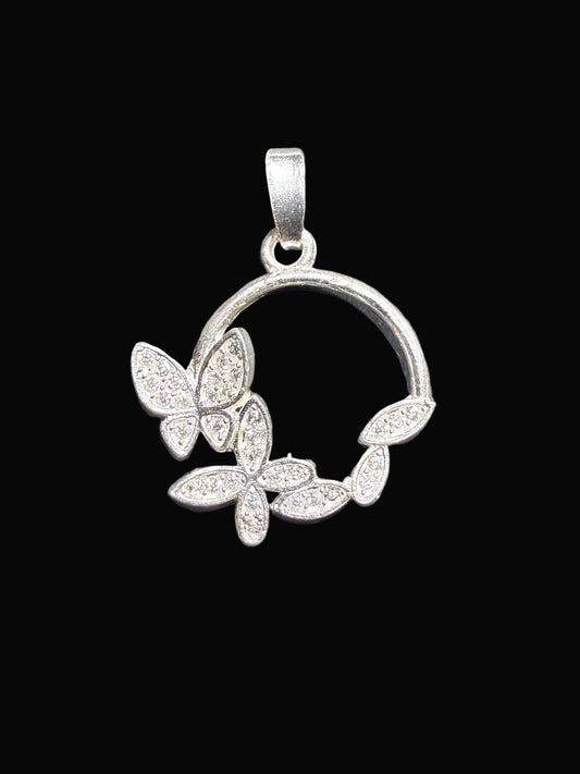 Silver pendant with butterfly design on a black background