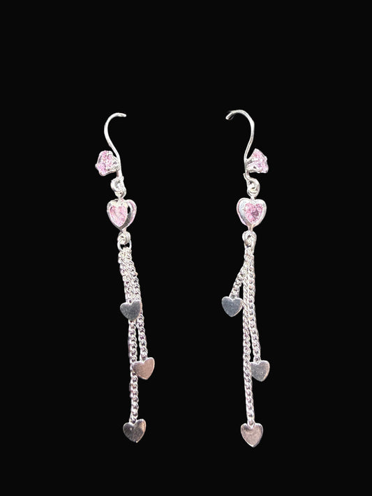 Pair of heart-shaped earrings on a black background