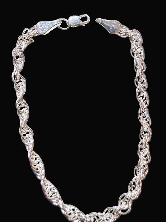 Silver chain bracelet on a dark gray surface