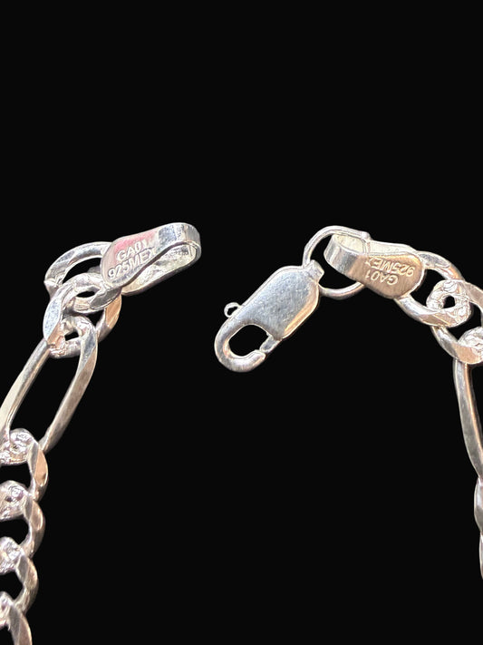 Silver chain bracelet on a textured black surface