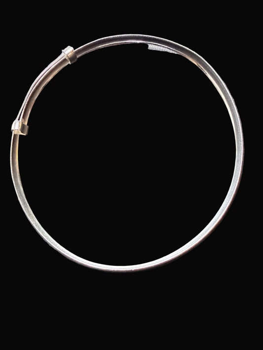 Silver bracelet on a gray surface