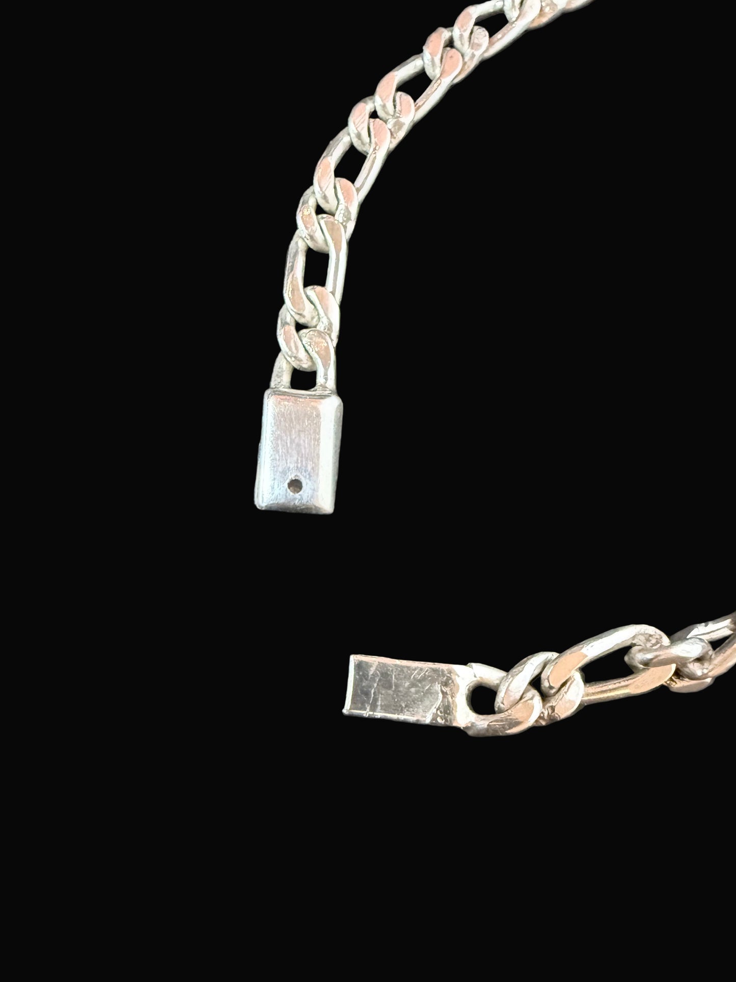 Silver bracelet on a dark wooden surface