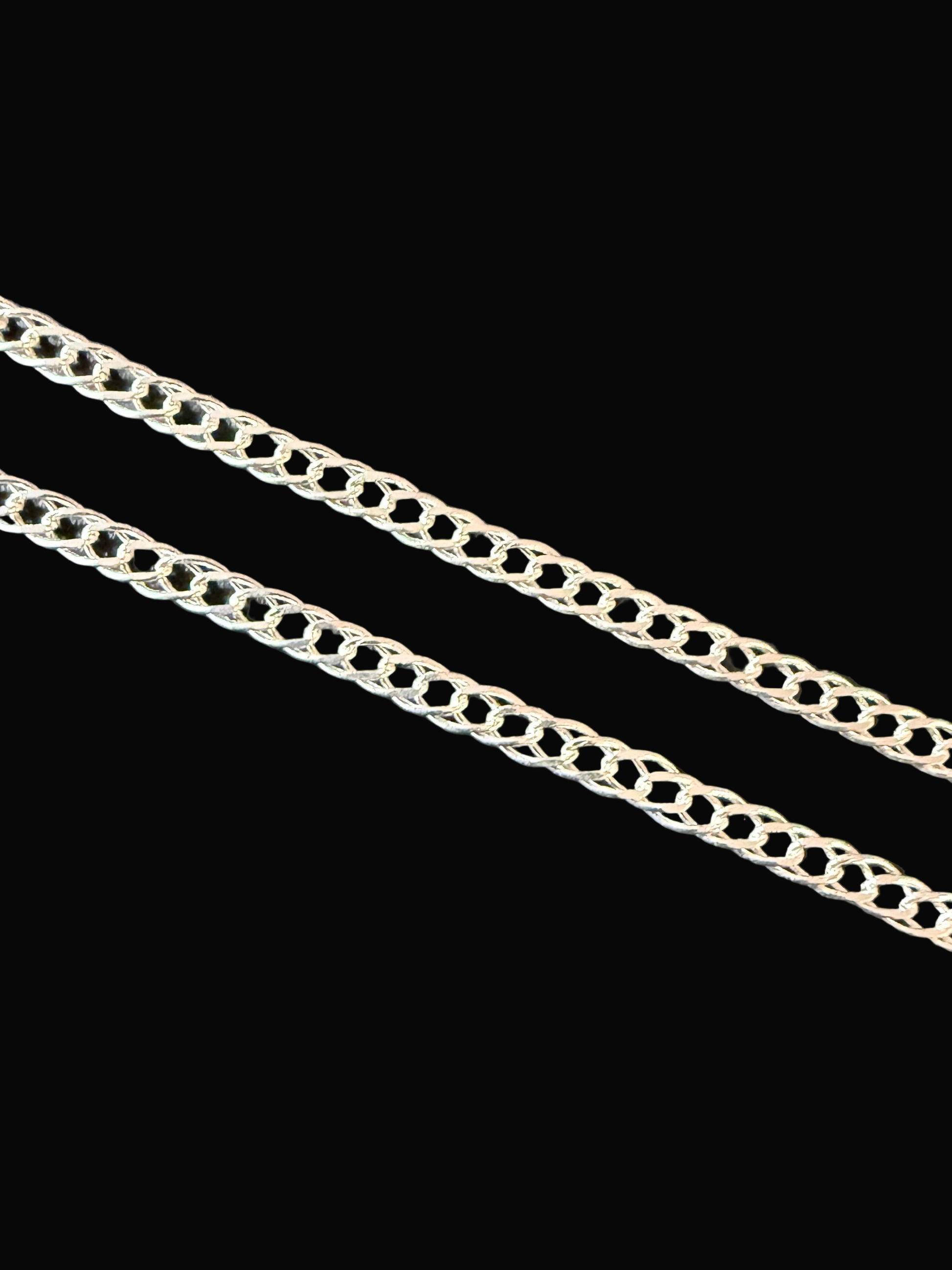 Silver chain on a dark textured surface