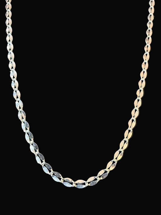 Silver chain on a dark textured surface