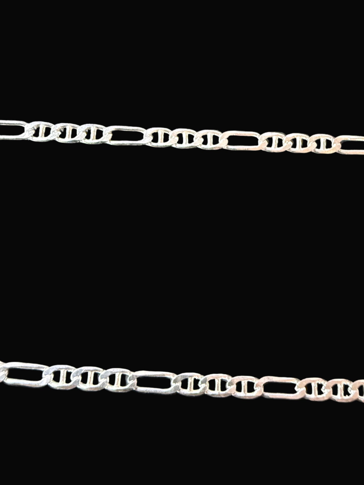 Silver chain on a dark textured surface