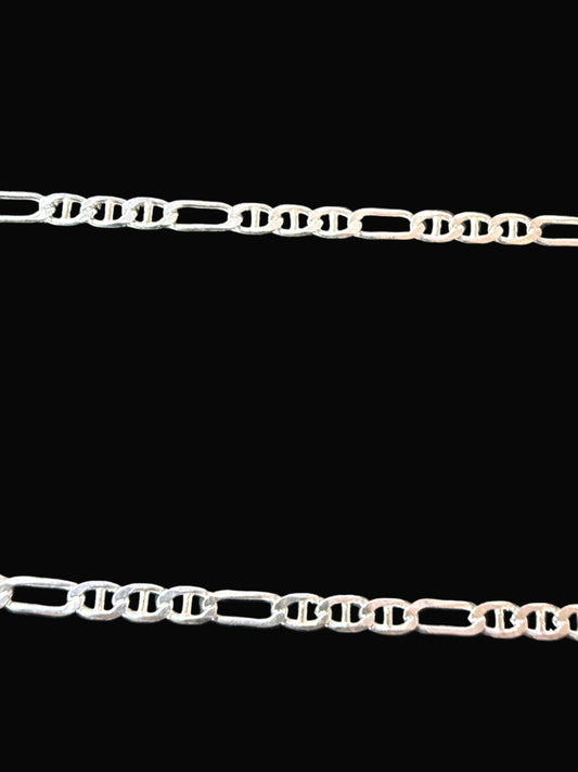 Silver chain on a dark textured surface